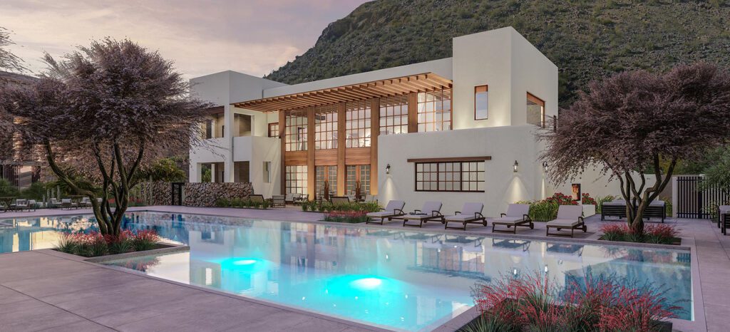Modern luxury residences with pool at dusk, surrounded by landscaped gardens and mountain backdrop.